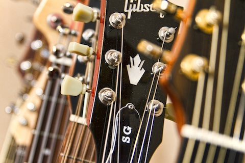 Cliff Smith Guitar Lessons London- close up of Cliff Smith's guitar rack, focus on Gibson SG Standard headstock.